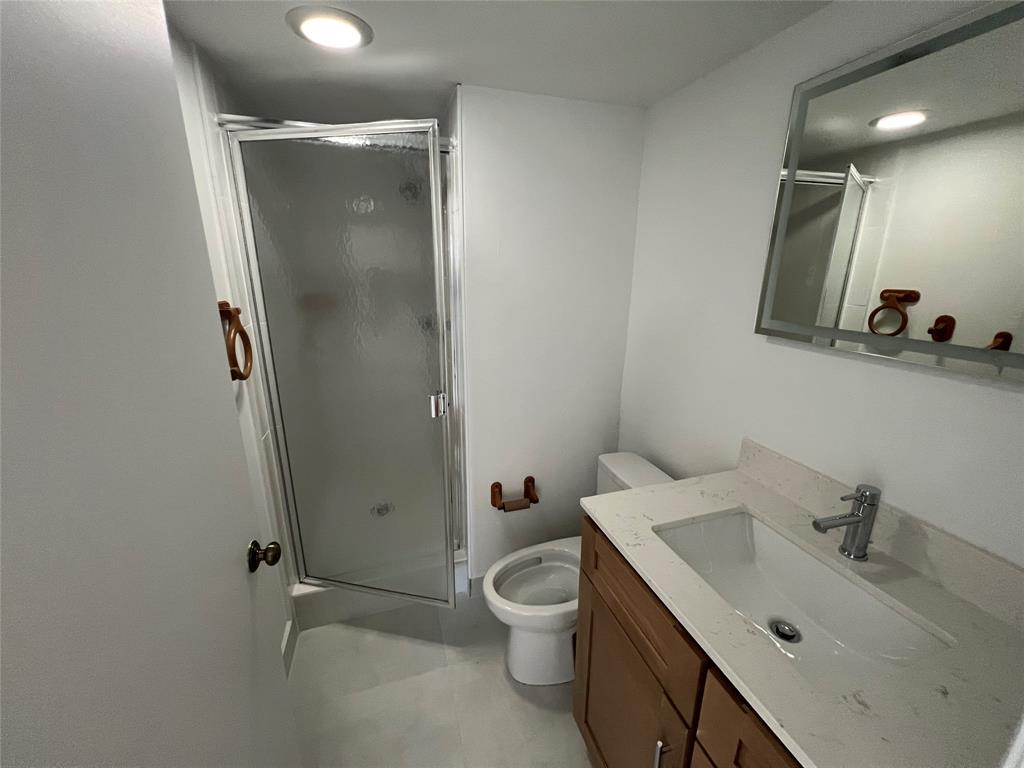 9300 Southwest 8th Street, Unit 422 Boca Raton, FL 33428 - Photo 38 of 38 a bathroom with a toilet sink and shower