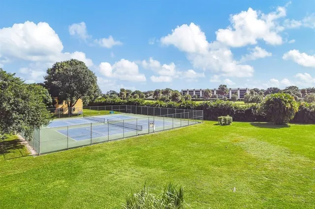 a view of a hallway with wooden floor and entryway