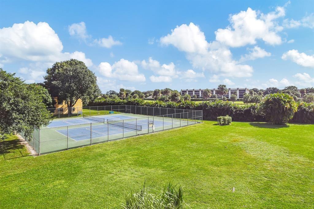 9300 Southwest 8th Street, Unit 422 Boca Raton, FL 33428 - Photo 5 of 38 a view of a swimming pool and a yard