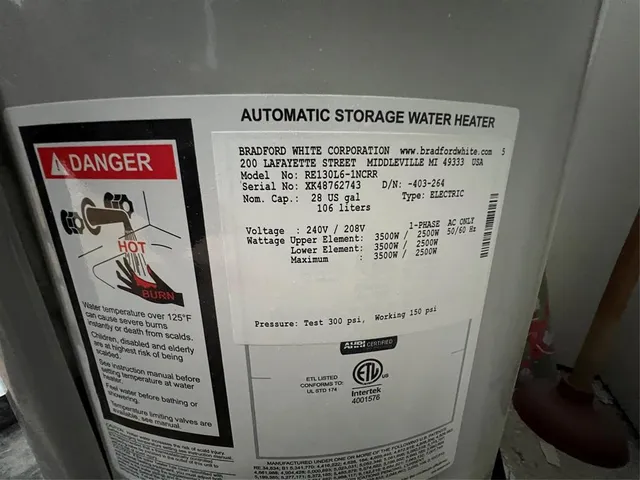 a kitchen with granite countertop a refrigerator and a sink