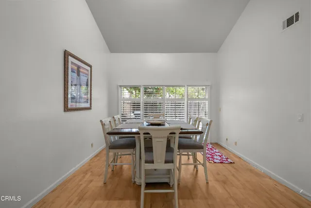 a view of a dining room with furniture and a wooden floor