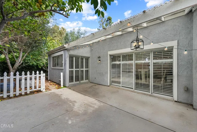 a view of a house with a tree and yard