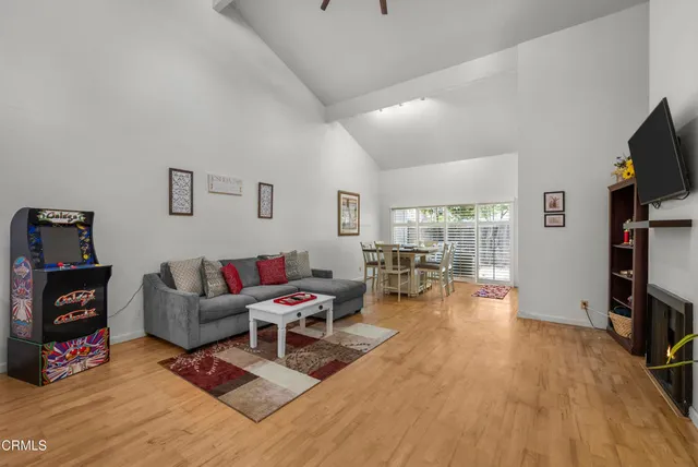 a living room with furniture a fireplace and a flat screen tv