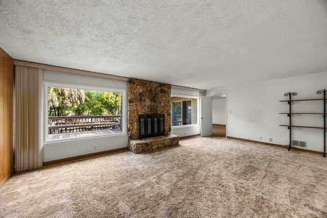 an empty room with furniture and windows