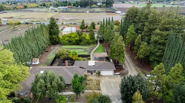 an aerial view of house with yard and lake view