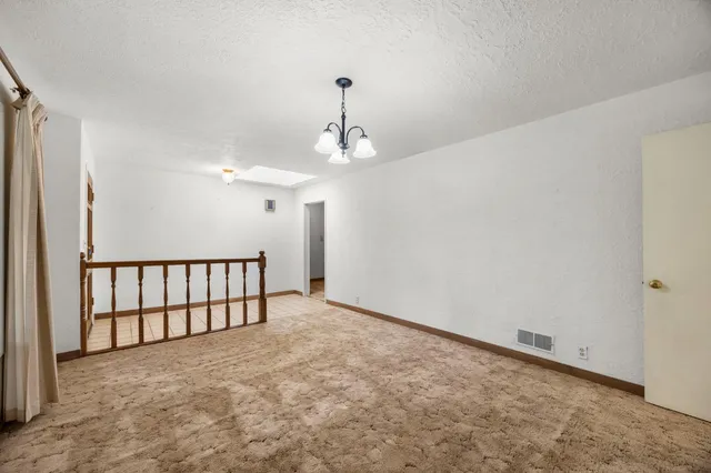 a view of a room with a ceiling fan