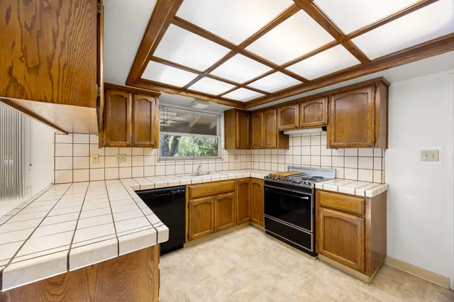 a kitchen with stainless steel appliances granite countertop a stove and a sink