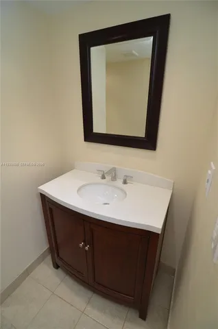 a bathroom with a sink vanity and a mirror