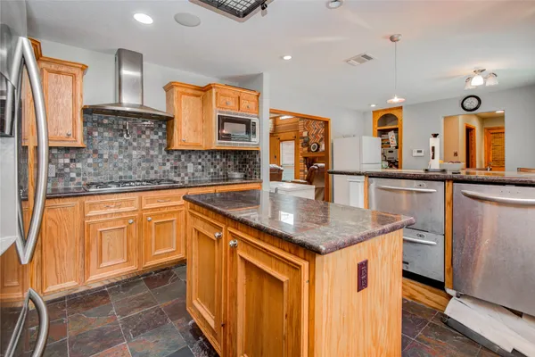 a kitchen with stainless steel appliances granite countertop a sink stove and refrigerator