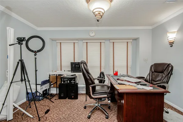 a view of a workspace with furniture and a window