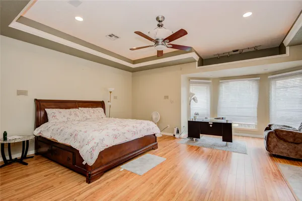 a bedroom with a bed and wooden floor