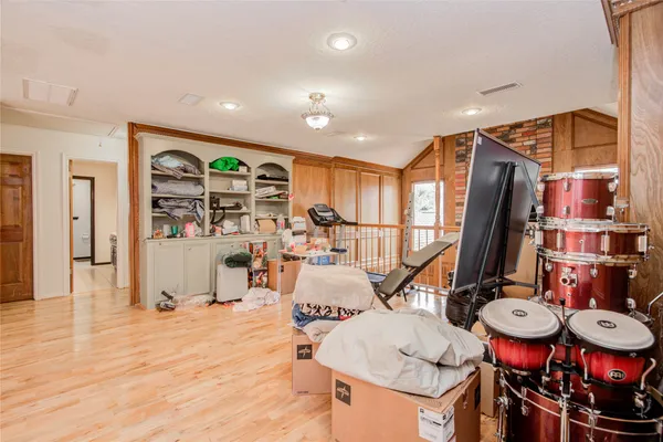 an empty room with windows and fan
