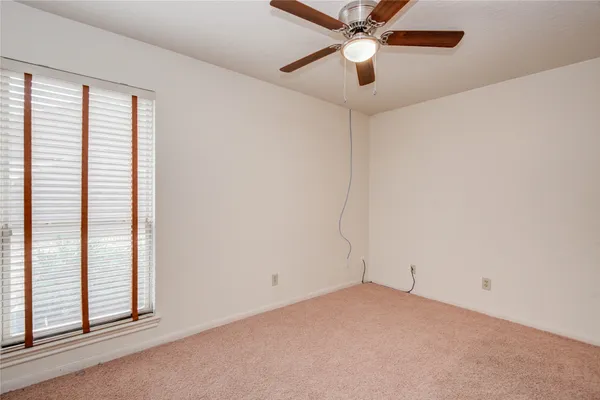 an empty room with a ceiling fan
