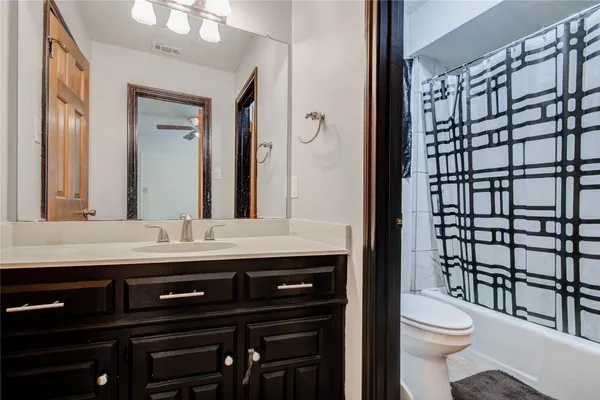 a view of a house with large windows and a small yard