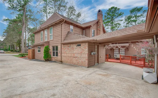 a view of a house with a balcony and trees