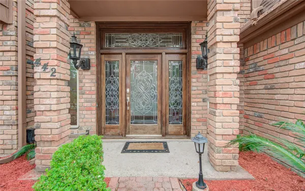 a couple of potted plants in front of a door