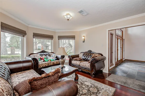 a living room with furniture ceiling fan and a rug