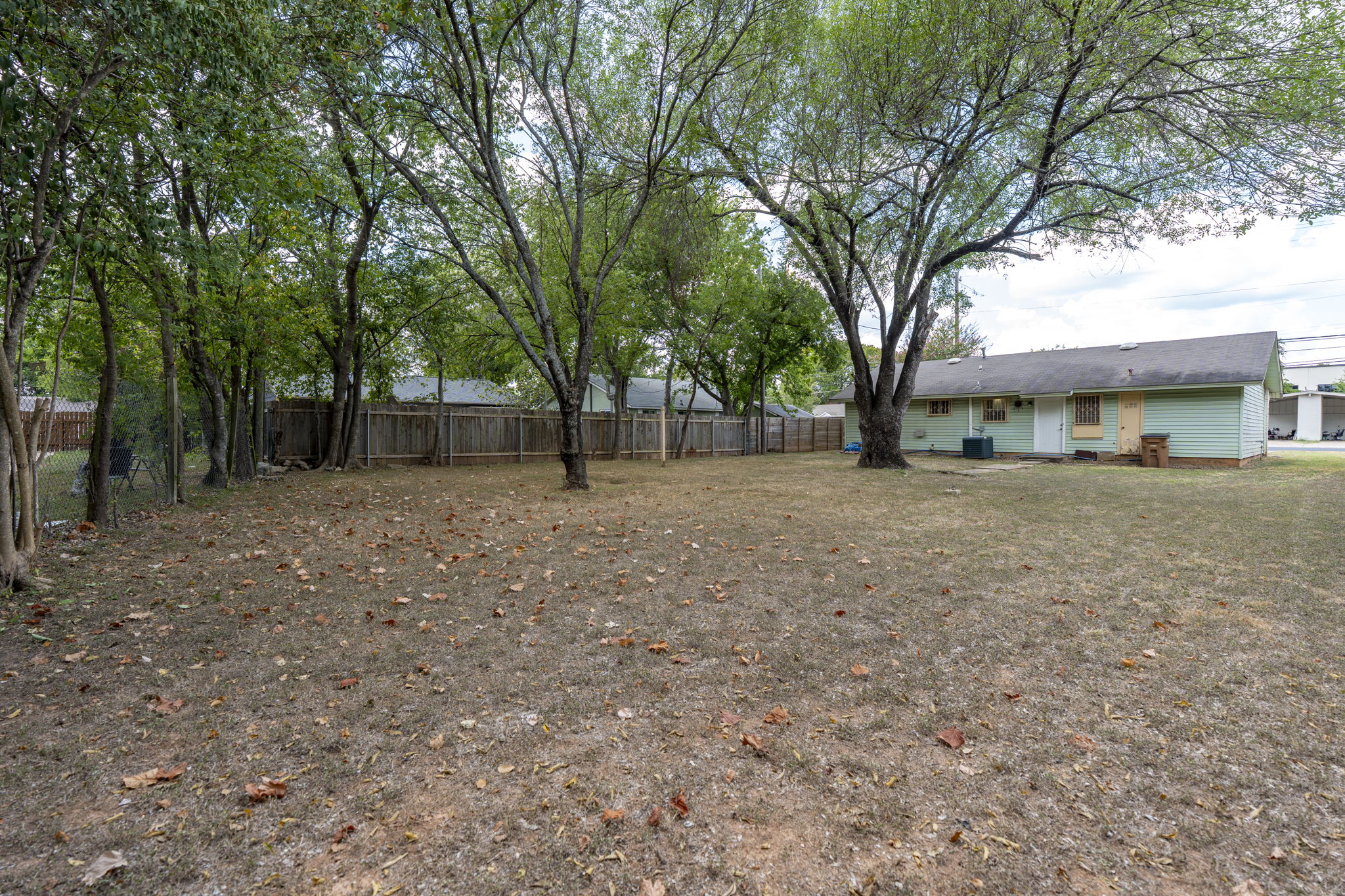 1021 Gardner Road Austin, TX 78721 - Photo 1 of 31 A spacious backyard with mature trees providing ample shade and natural privacy