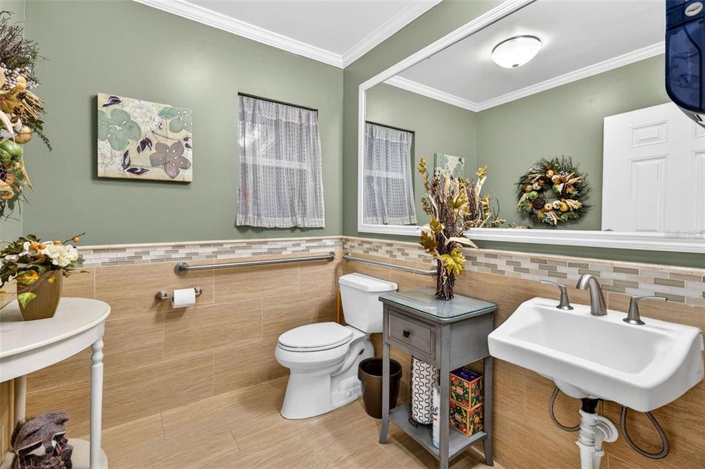 12574 Indian Rocks Road Largo, FL 33774 - Photo 12 of 32 a bathroom with a sink mirror and toilet