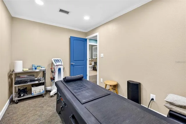 a view of a workspace with furniture and a window