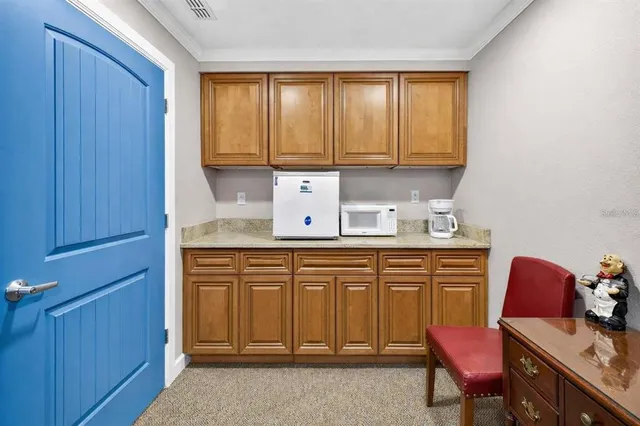 a work room with furniture and a computer