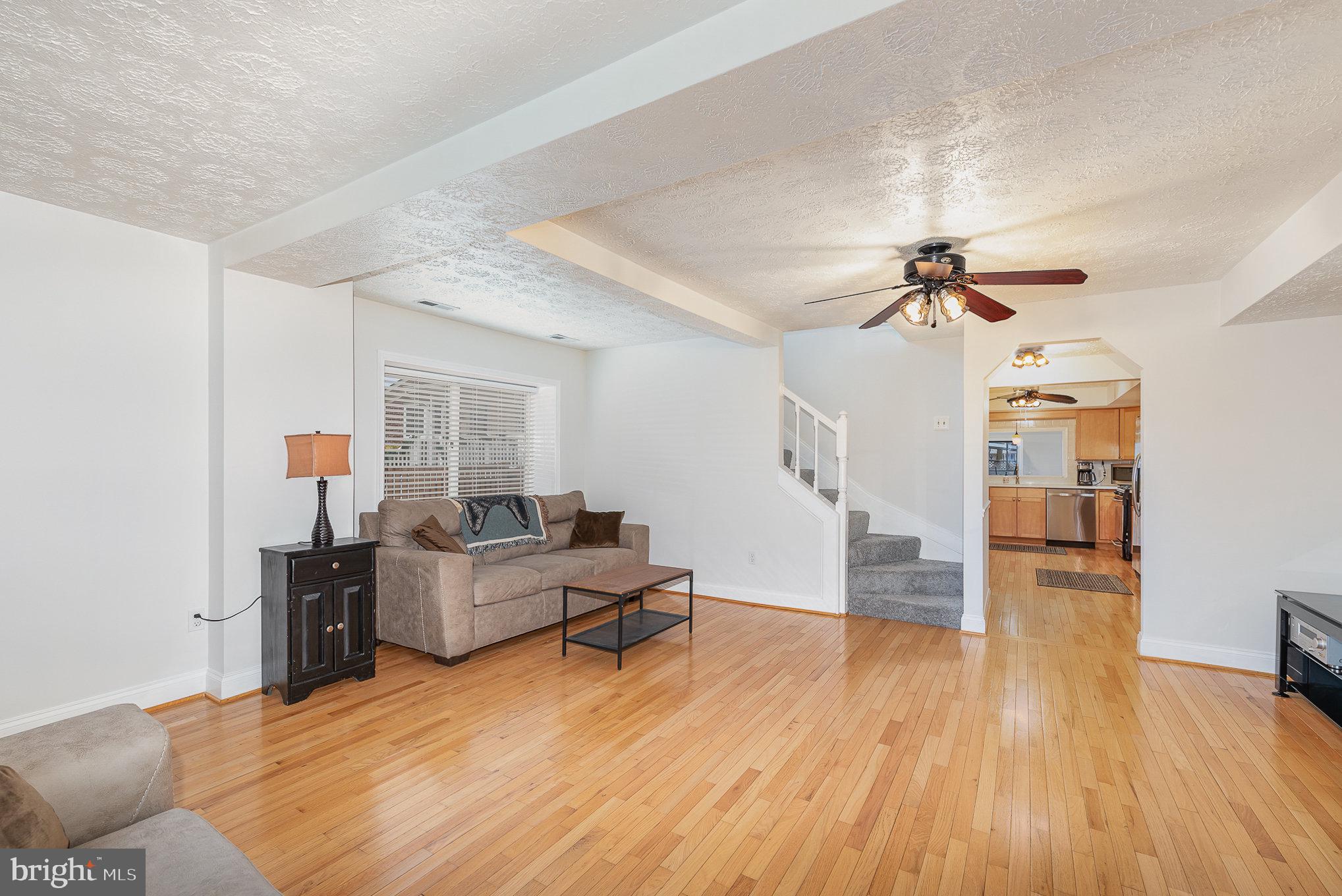 7219 River Drive Road Sparrows Point, MD 21219 - Photo 15 of 38 a living room with furniture and a wooden floor