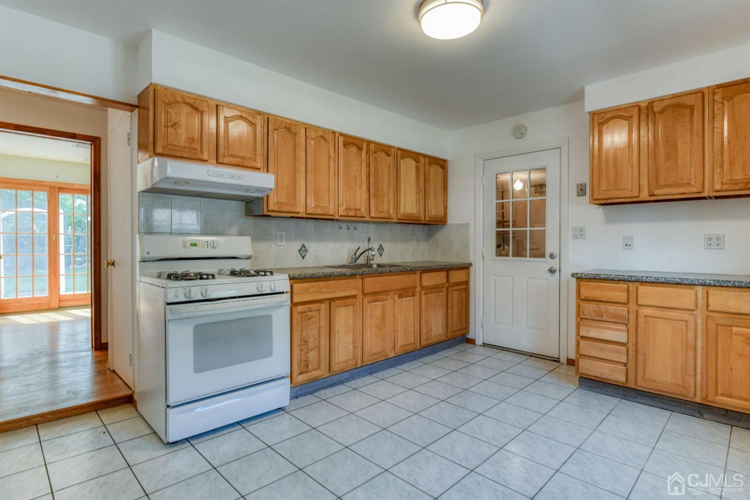 28 Cambridge Road Edison, NJ 08817 - Photo 22 of 30 a kitchen with stainless steel appliances granite countertop a stove sink and cabinets