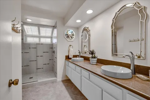 a bedroom with a large bed and a chandelier