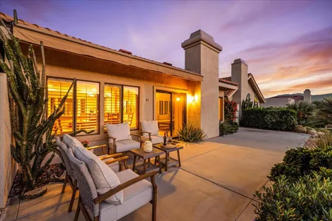 a patio with yard glass top table and chairs