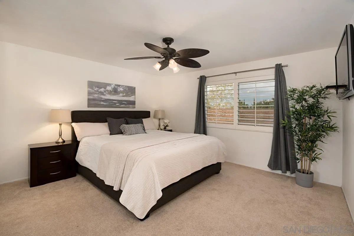 11068 Pinzon Way San Diego, CA 92127 - Photo 15 of 31 a bedroom with a bed and a potted plant