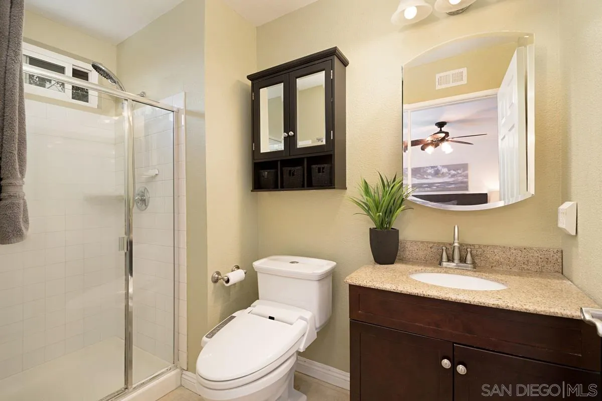 11068 Pinzon Way San Diego, CA 92127 - Photo 17 of 31 a bathroom with a sink a toilet and shower