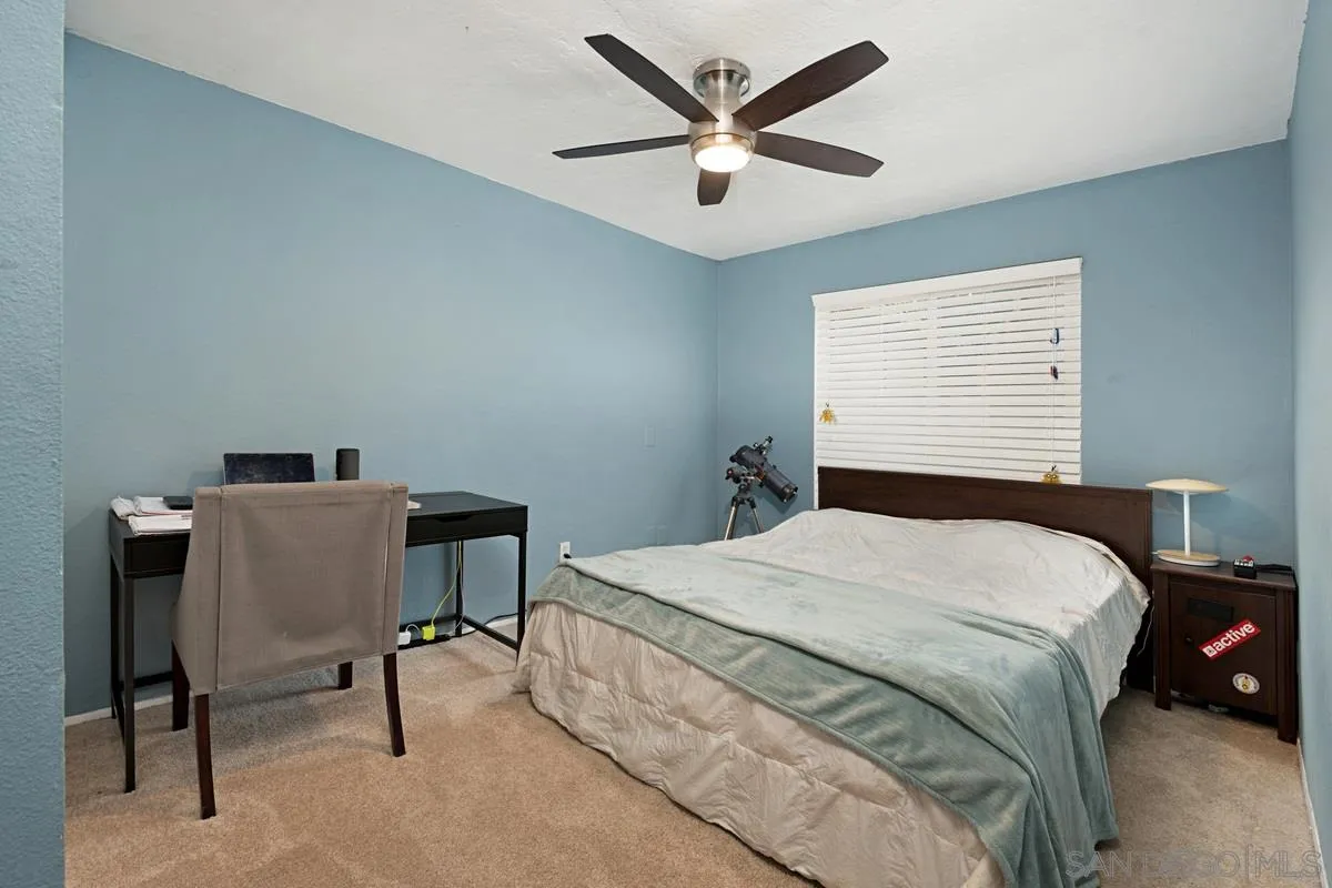 11068 Pinzon Way San Diego, CA 92127 - Photo 18 of 31 a bedroom with a bed and a desk