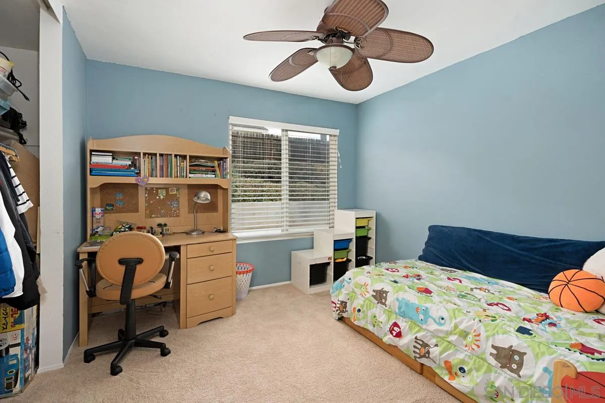 11068 Pinzon Way San Diego, CA 92127 - Photo 19 of 31 a bedroom with a bed and a chandelier