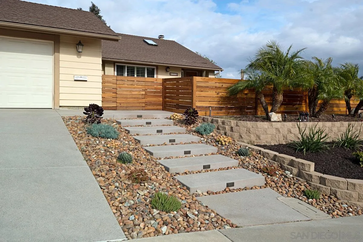11068 Pinzon Way San Diego, CA 92127 - Photo 2 of 31 a front view of a house with garden