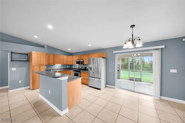 a kitchen with stainless steel appliances granite countertop a refrigerator and a stove top oven
