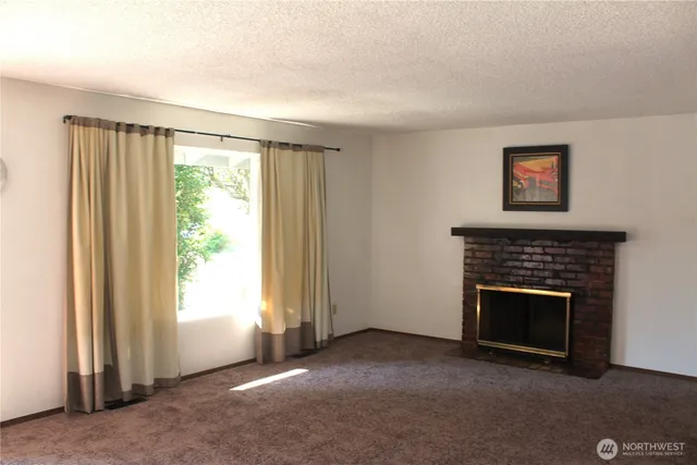 an empty room with windows lake and mountain view