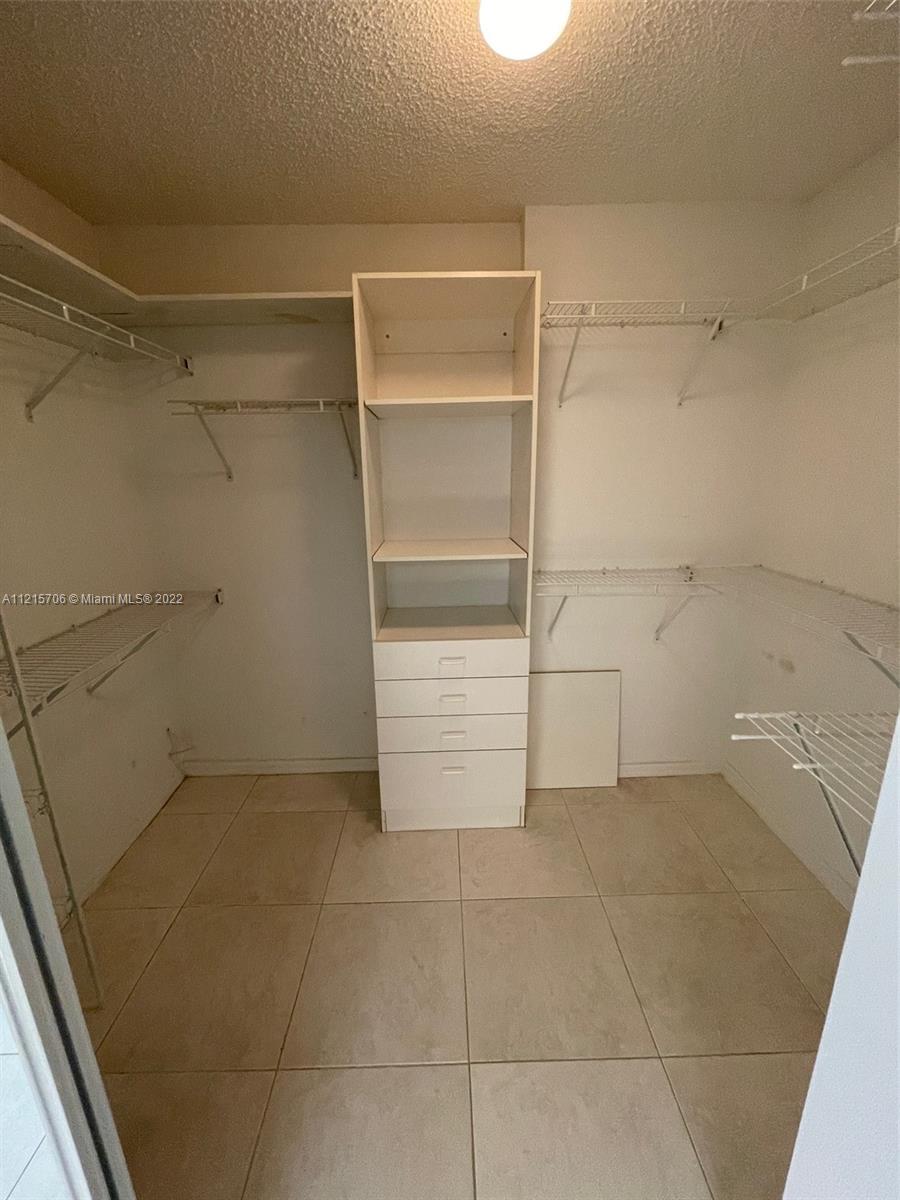 9599 Weldon Circle, Unit A304 Tamarac, FL 33321 - Photo 4 of 12 a view of an empty walk in closet