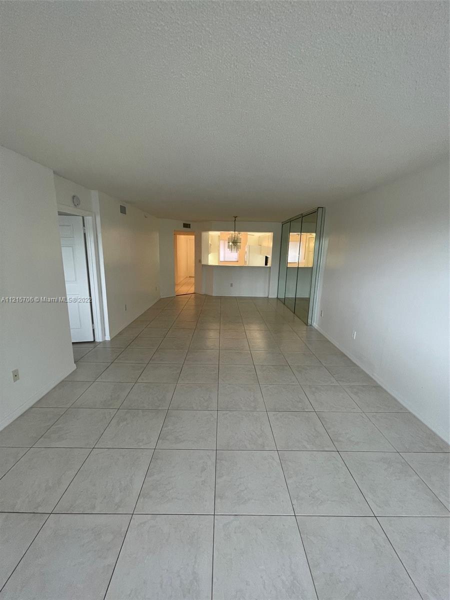 9599 Weldon Circle, Unit A304 Tamarac, FL 33321 - Photo 7 of 12 a view of an empty room and window