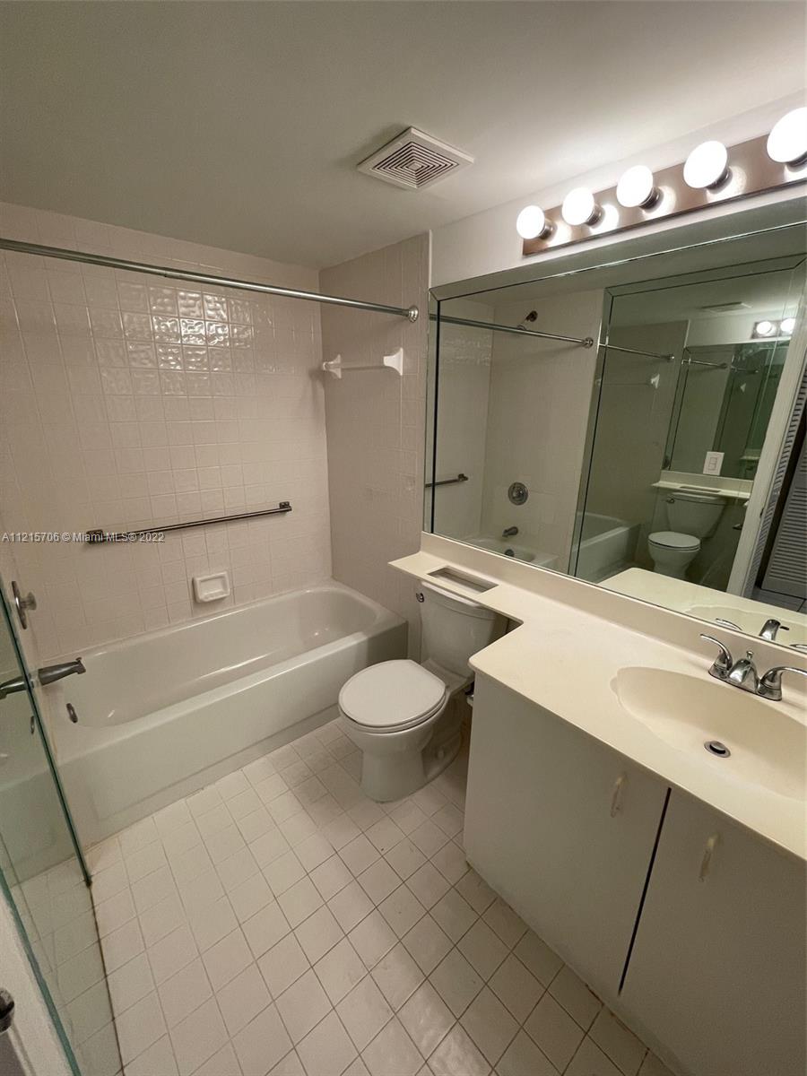 9599 Weldon Circle, Unit A304 Tamarac, FL 33321 - Photo 9 of 12 a bathroom with a sink a toilet and shower