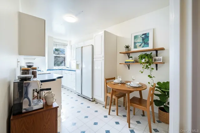 a kitchen with stainless steel appliances kitchen island granite countertop a refrigerator and a stove top oven