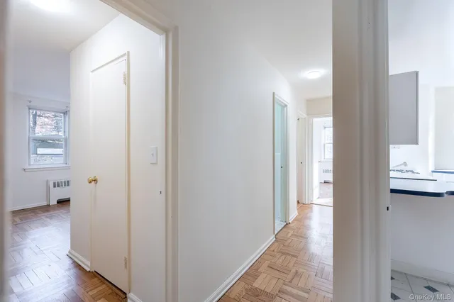 a view of an empty room and wooden floor