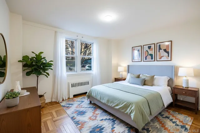a bedroom with a bed and a potted plant