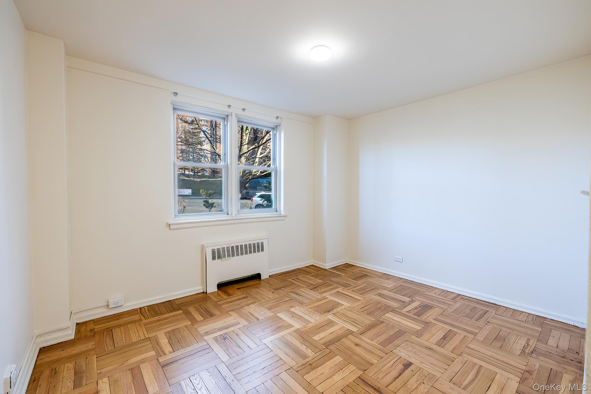 55 Knolls Crescent, Unit 2D Bronx, NY 10463 - Photo 15 of 24 a view of an empty room with a window