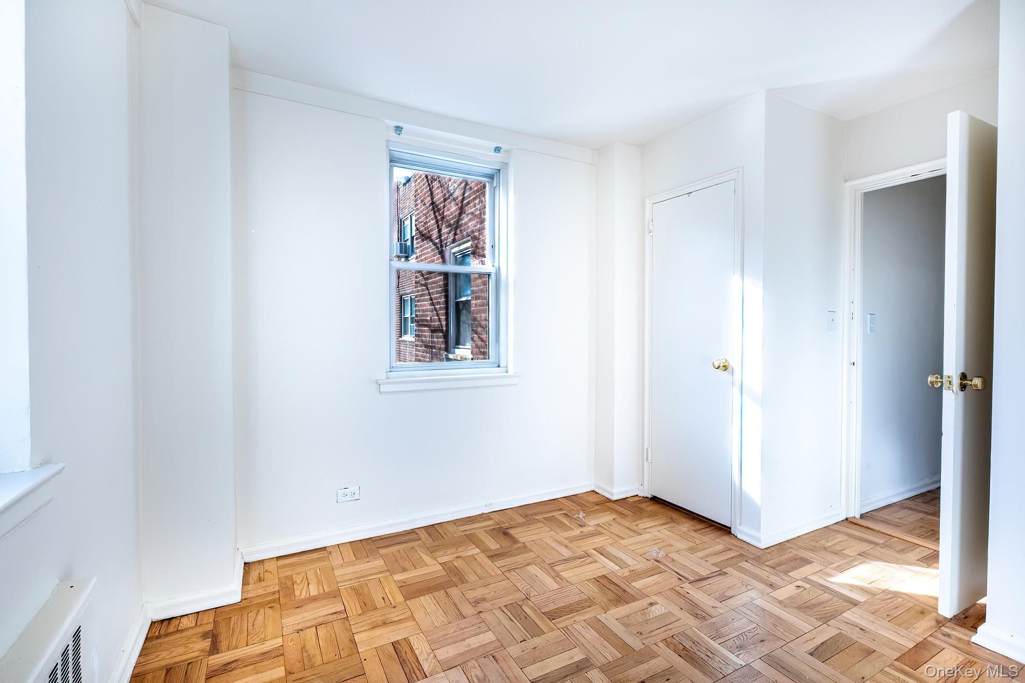 55 Knolls Crescent, Unit 2D Bronx, NY 10463 - Photo 16 of 24 a view of a bedroom with window