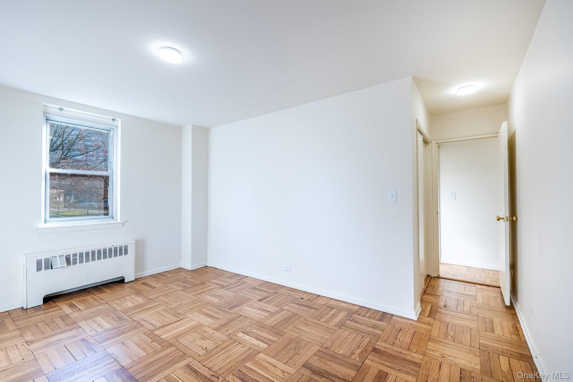 55 Knolls Crescent, Unit 2D Bronx, NY 10463 - Photo 18 of 24 a view of an empty room and window