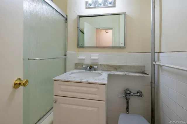a bathroom with a granite countertop sink a toilet and mirror