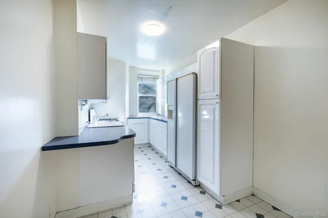 a kitchen with refrigerator and window