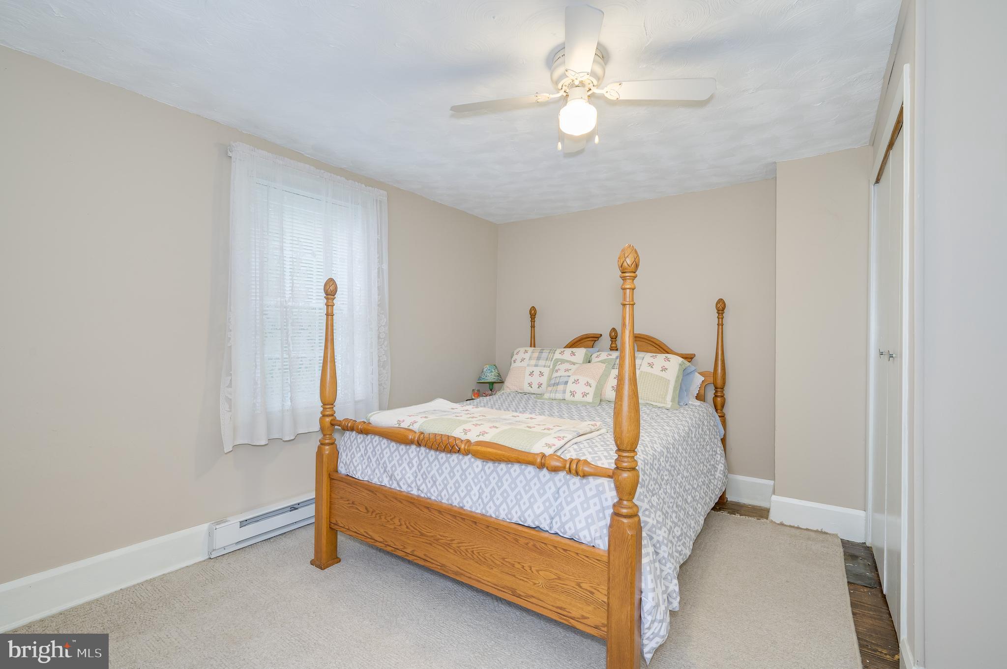 101 North Mildred Street Ranson, WV 25438 - Photo 51 of 75 a bedroom with a bed and a chandelier