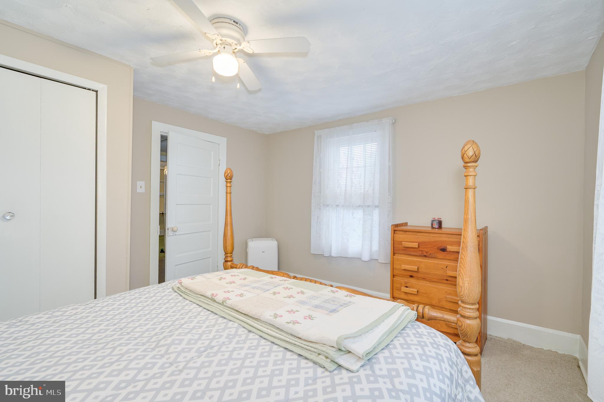 101 North Mildred Street Ranson, WV 25438 - Photo 53 of 75 a bedroom with a bed and a chandelier