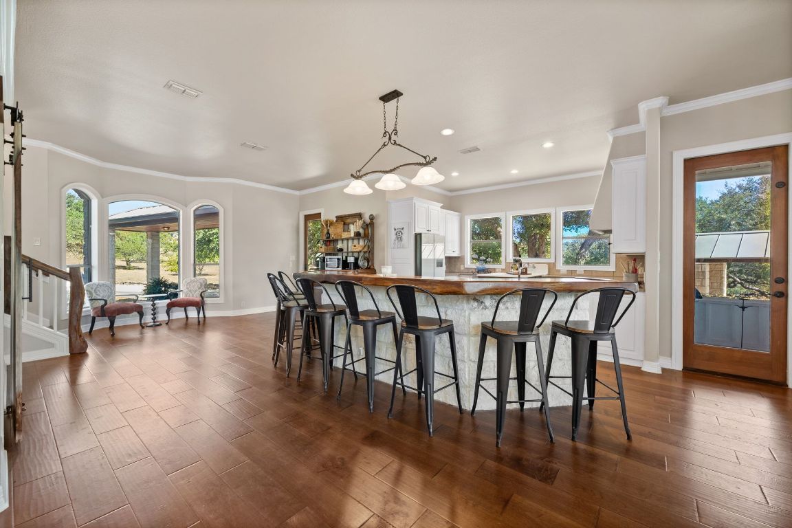 185 Shimmering Shore Court Spring Branch, TX 78070 - Photo 12 of 40 a dining room with furniture window wooden floor and a rug